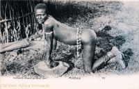 Kavirondo woman grinding corn