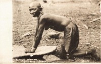 Kikuyu woman grinding grain