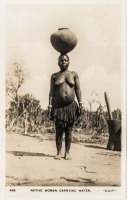 Native woman carrying water