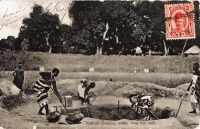 Natives drawing water from the well