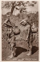 A "Kikuyu" woman and girl carrying water. Kenya